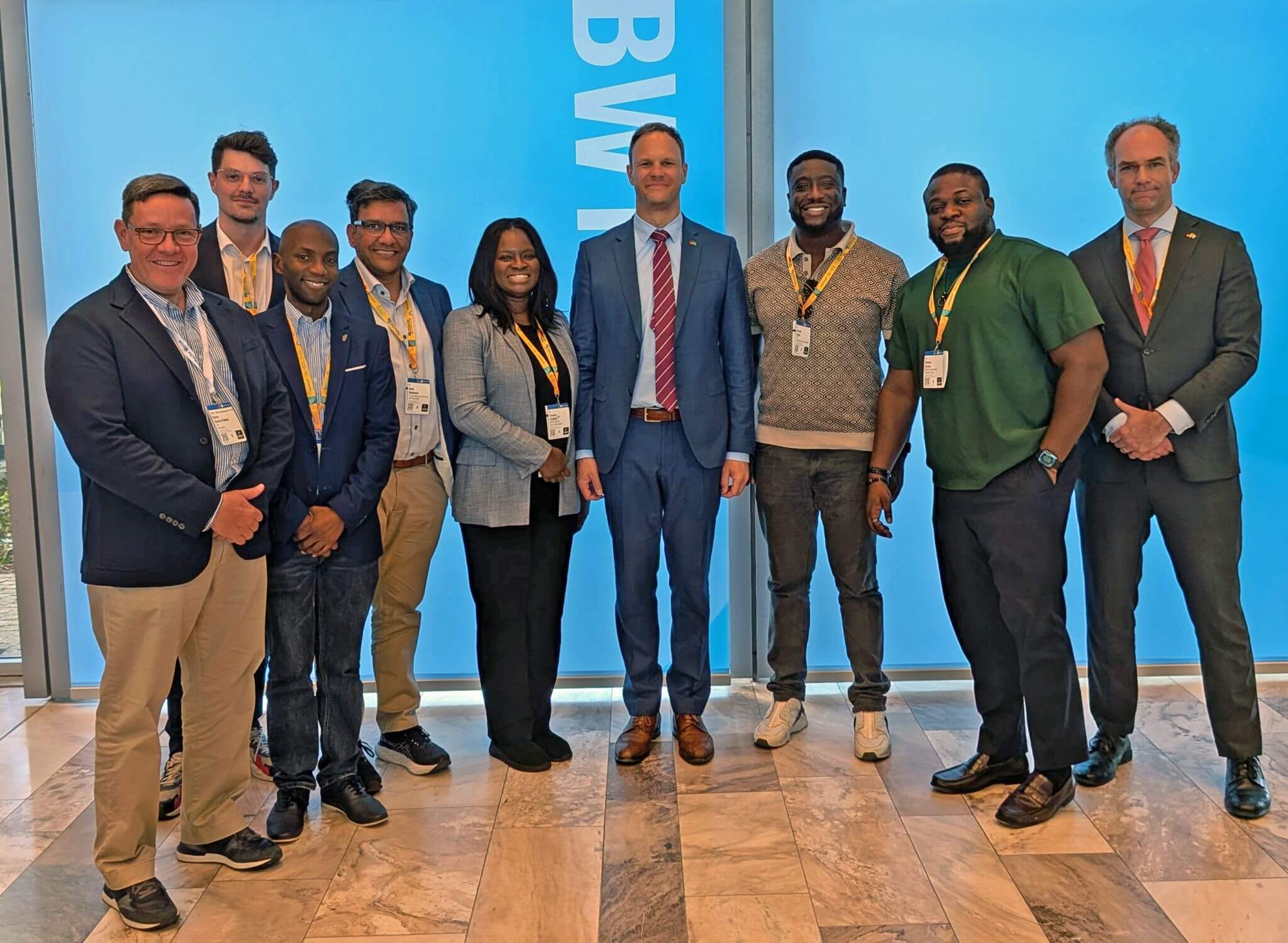 Members of an international delegation pose alongside representatives of a German federal ministry during an exchange meeting.
